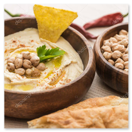 Creamy hummus topped with olive oil and paprika