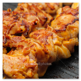 Chicken shish skewers searing over charcoal