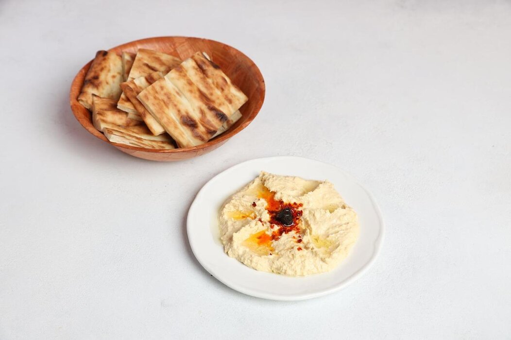 Bowl of hummus with olive oil and paprika