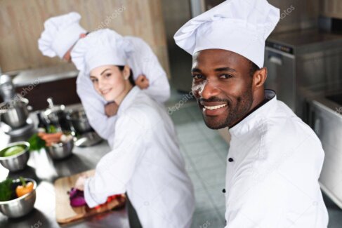 Kitchen and front-of-house team smiling inside the restaurant